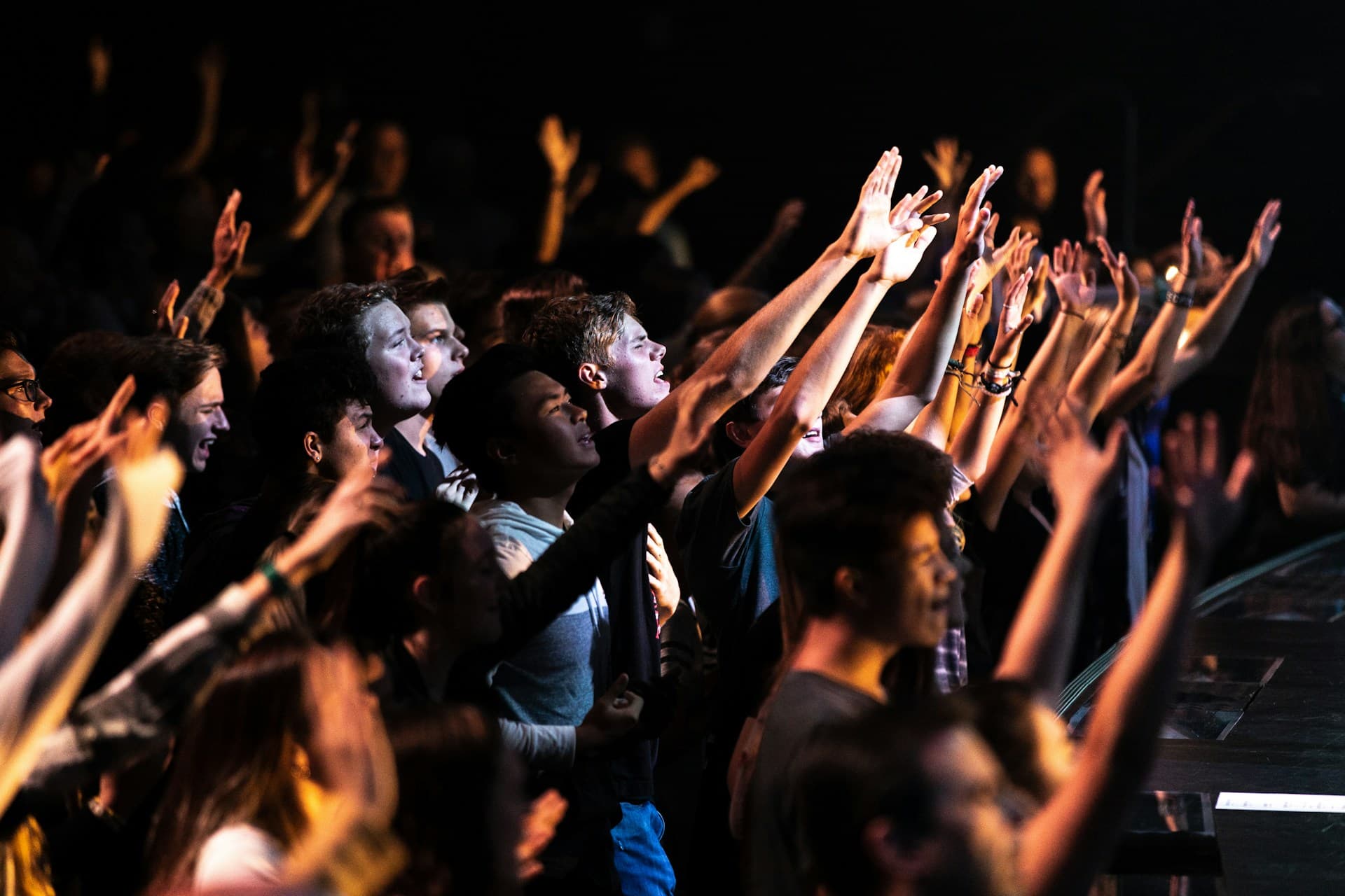 Youth with hands raised in worship at a Flaming Fire Movement gathering